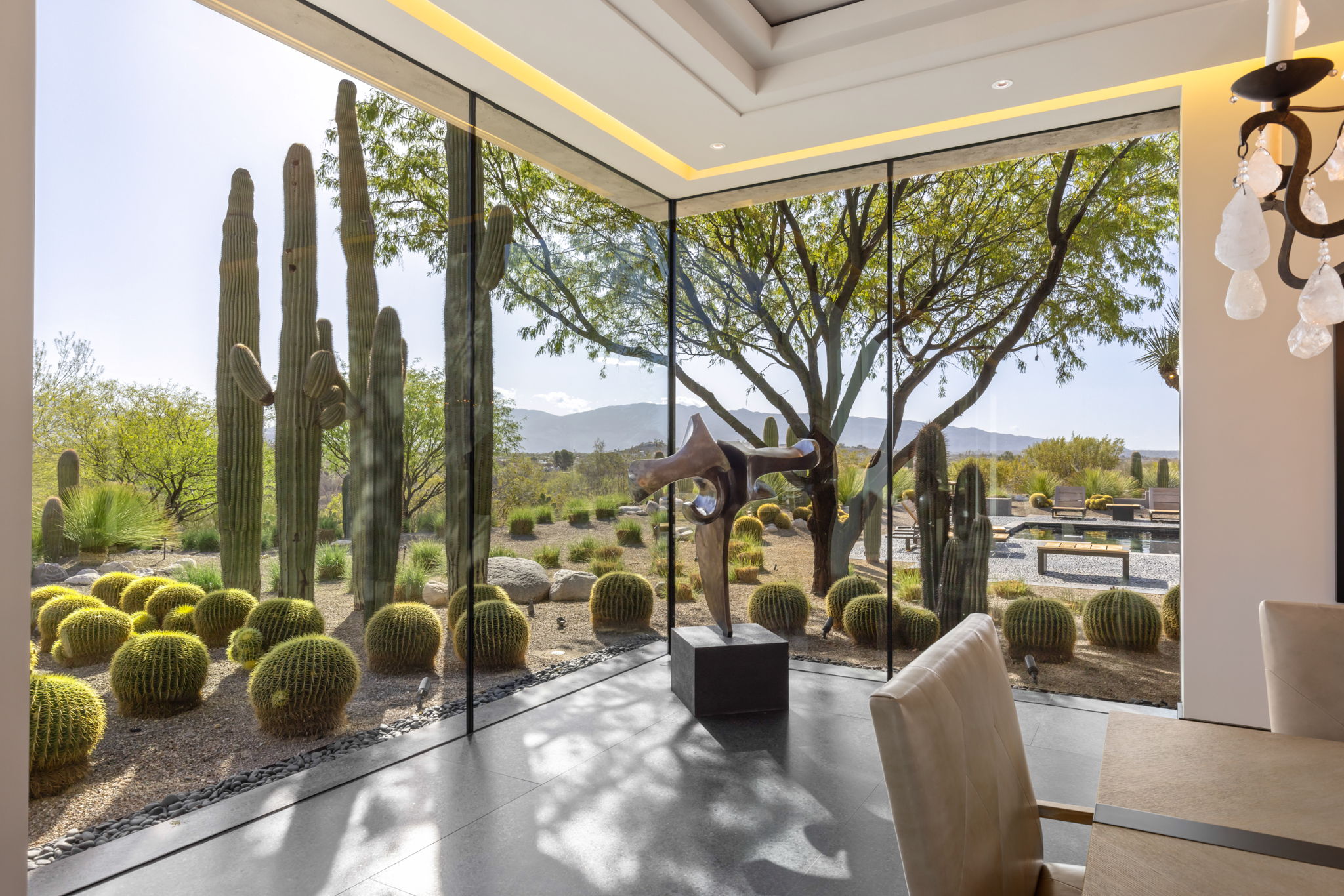 Canyon Ranch Estate — sculpture in glass corner with cactus garden beyond