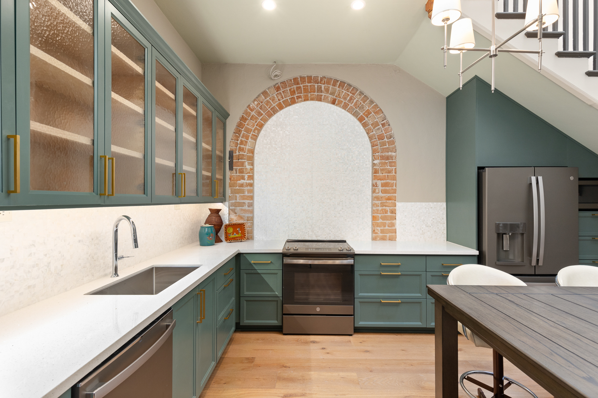 The Glenwood Hotel adaptive reuse — original brick archway preserved over the modern kitchen, photographed by Shadowpoint