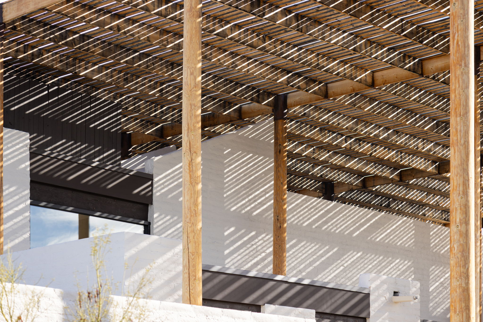 The Ramada House — canopy detail, shadow play across stucco