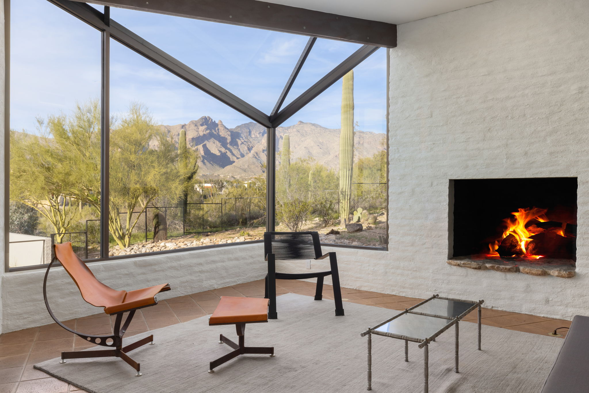 The Ramada House — living room with fireplace and angled glazing