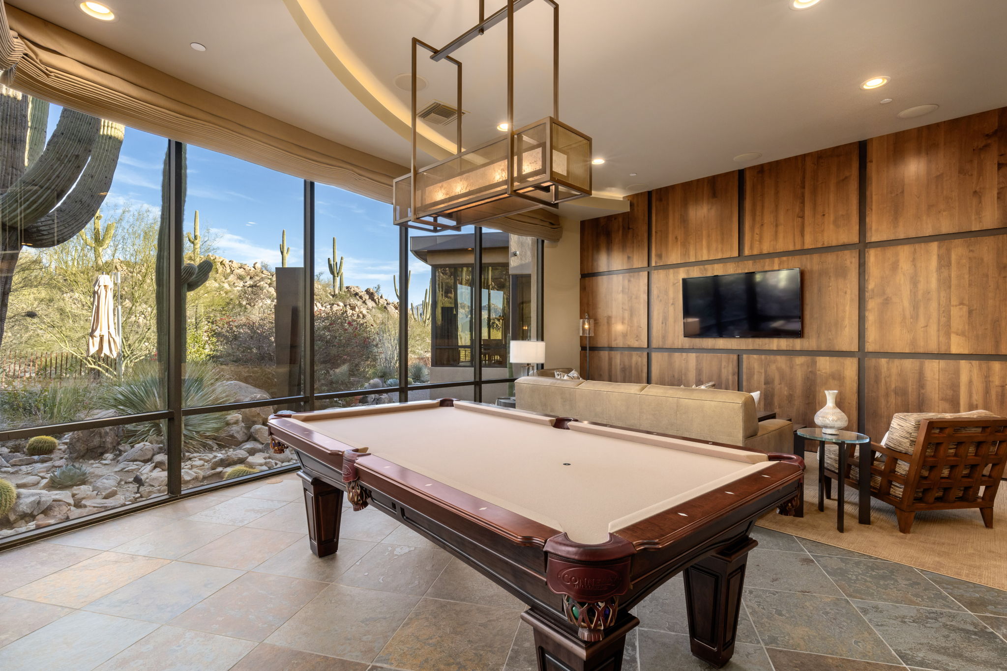 Tortolita Mountain Residence — billiards room with curving glass and saguaros